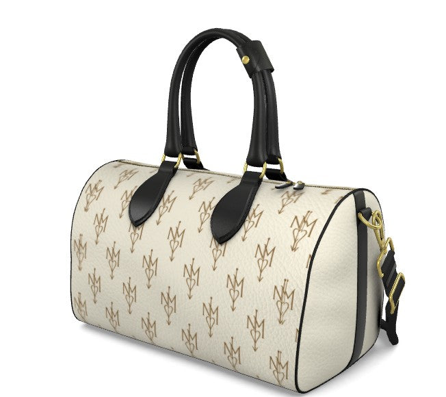 A cylindrical duffel bag with a cream-colored textured body featuring a repeating gold monogram pattern, black leather handles and trim, and gold-tone hardware.